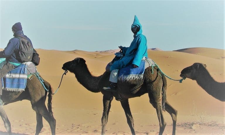 Sue on a camel in her djellaba, Merzouga, Morocco