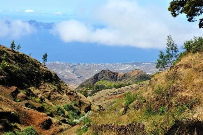 A view from the rugged volcanic slopes near Pico da Cruz on the island of Santo Antão in Cape Verde, looking down a dramatic valley toward the distant ocean