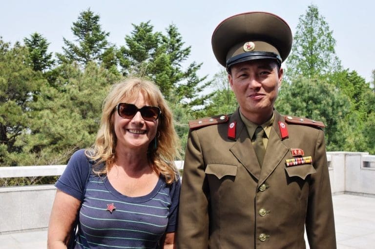 Sue and a Korean soldier at the DMZ in North Korea