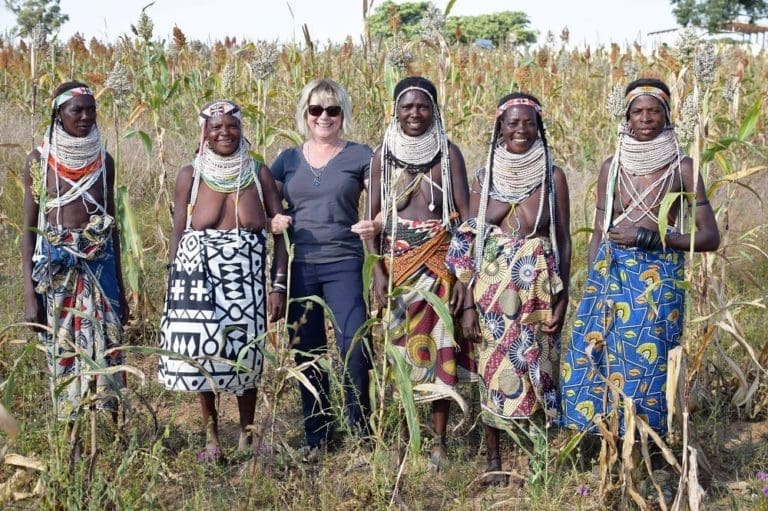 Sue with Handa women with huge beaded necklaces in the corn in Angola