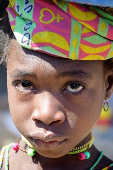 Angola - headshot of young Muila girl with colourful turban Angola