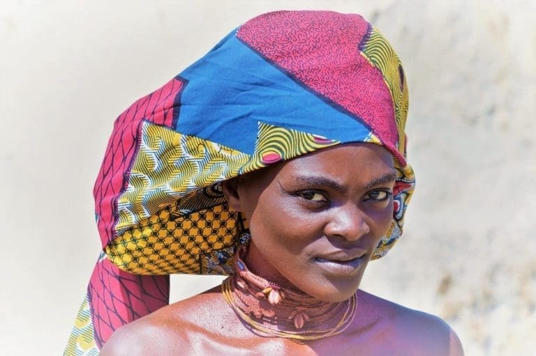 A headshot of a Mucabal woman with typical framed ompota headdress in Angola