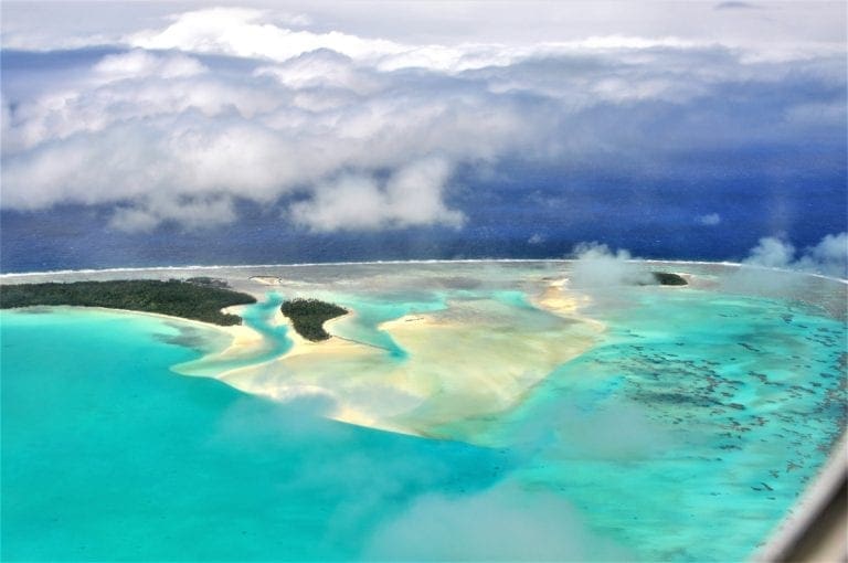 Jade coloured Aitutaki Lagoon and reef rom the air