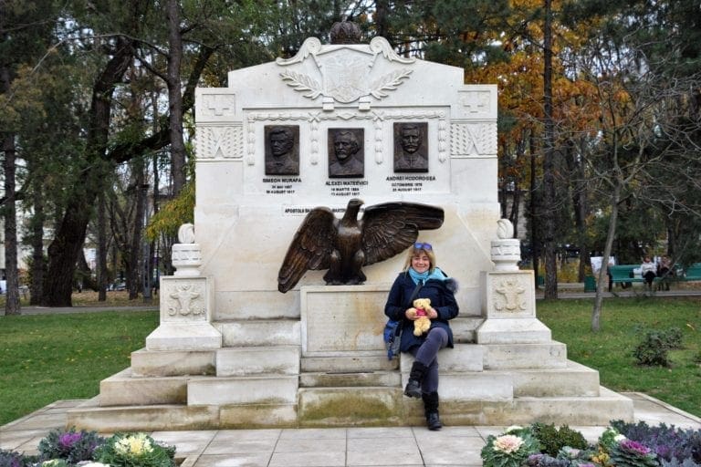 Sue sitting in front of a memorial in Chisinau